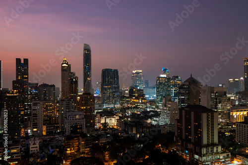 Panoramic view of Bangkok skyline at sunset. Modern city center of capital of Thailand. Contemporary buildings exterior with glass.