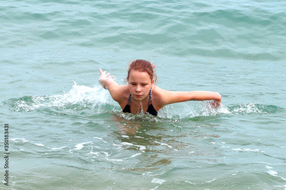 girl swims in the sea close-up                               