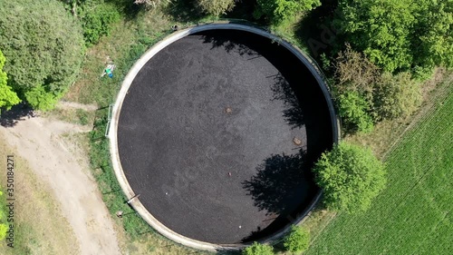 Aerial view of the flight over three huge slurry ponds for drying pig manure from a farm