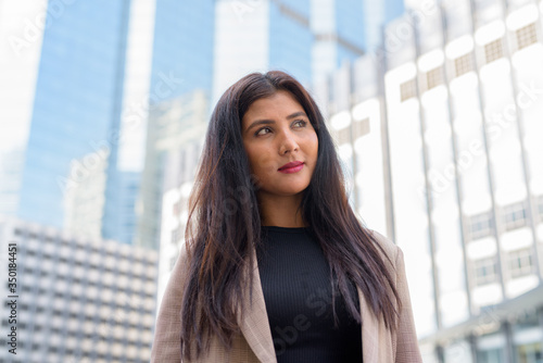 Face of young beautiful Indian businesswoman thinking against view of the city Free Download Face of young beautiful Indian businesswoman thinking against view of the city - GFXLoad