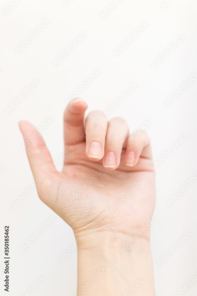 Close up woman hand with nails form of soft square holds something in fingers. Female keeps virtual object. Nail care at home. Copy space. Close up woman hand with nails form of soft square holds something in fingers. Female keeps virtual object. Nail care at home. Copy space.