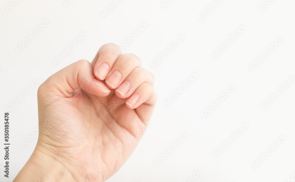 Close up woman hand with nails form of soft square holds something in fingers. Female keeps virtual object. Nail care at home. Copy space. Close up woman hand with nails form of soft square holds something in fingers. Female keeps virtual object. Nail care at home. Copy space.