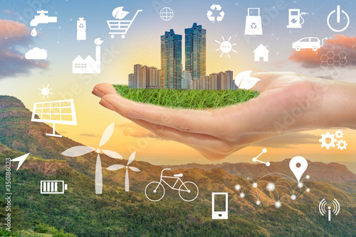 Hand hold green city with ecological icons, Save earth concept photo