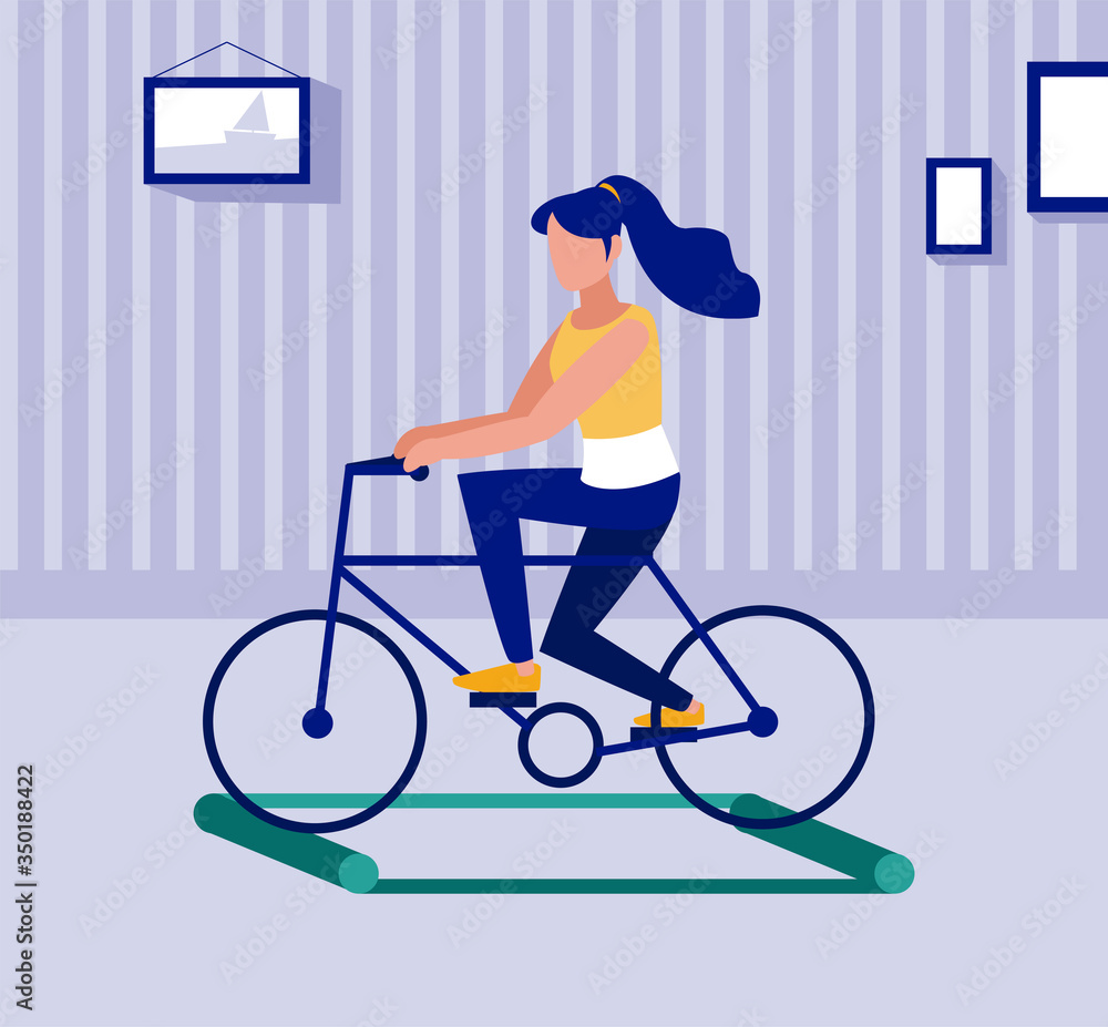 woman on bicycle on training rollers, social distancing woman on bicycle on training rollers, social distancing