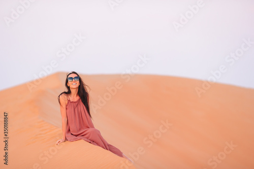 Girl among dunes in desert in United Arab Emirates © travnikovstudio