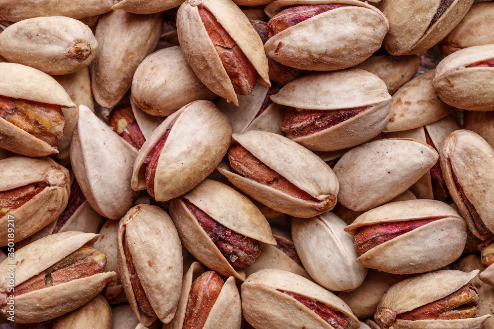 Pistachios texture and background . Tasty pistachios as background,as pistachios texture.Concept of nuts. flat lay Pistachios texture and background . Tasty pistachios as background,as pistachios texture.Concept of nuts. flat lay