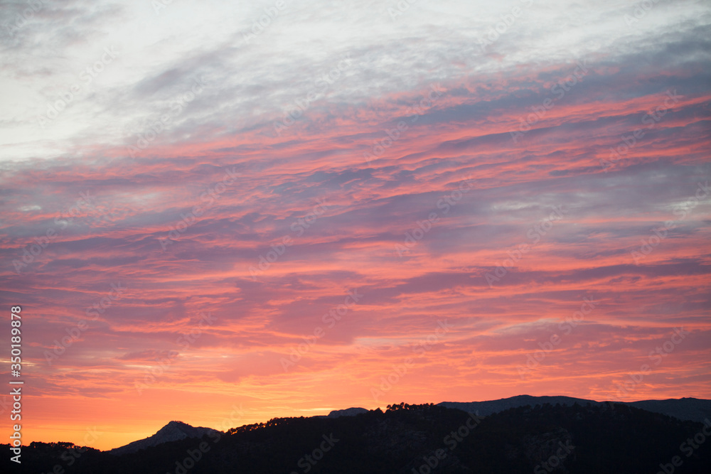 Mountainous landscape of the Tramuntana mountains. 
 Sunset time at Andratx village in Majorca