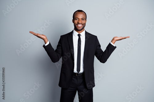 Portrait of his he nice attractive chic classy elegant cheerful cheery content guy recruiter holding copy space on palms decision isolated over grey pastel color background