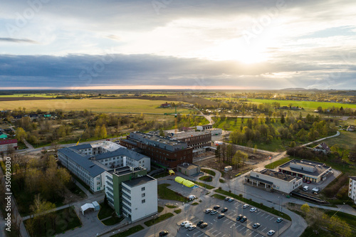 Aerial cityscape panoramic view of building construction near the hospital at sunset. 