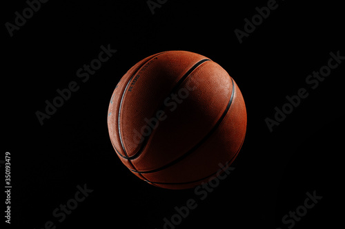 Basketball ball on a black background © Иван Супрунов