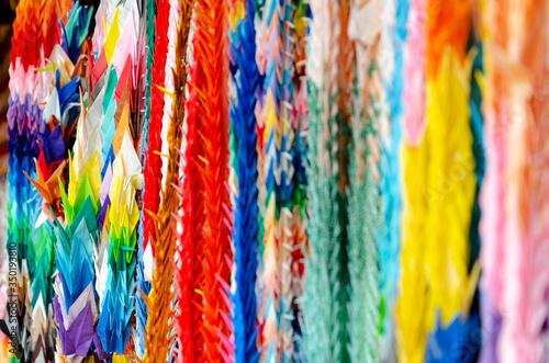 colorful paper cranes hanging on a thread in a Japanese temple