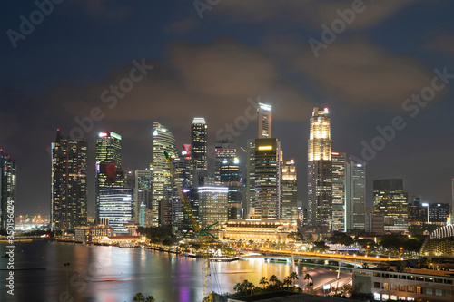 Picturesque panoramic view of Singapore city at night time. Financial and trading center hub in Asia region. Concept of success. Modern buildings in high-tech world.