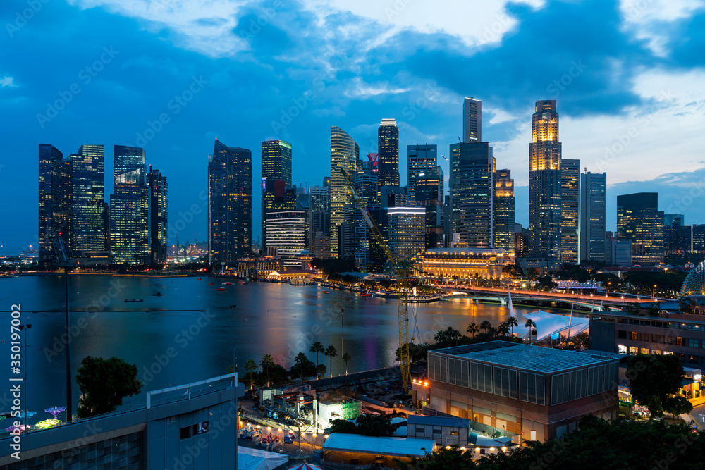 Fototapeta premium Picturesque panoramic view of Singapore city at sunset. Financial and trading center hub in Asia region. Concept of success. Modern buildings in high-tech world.