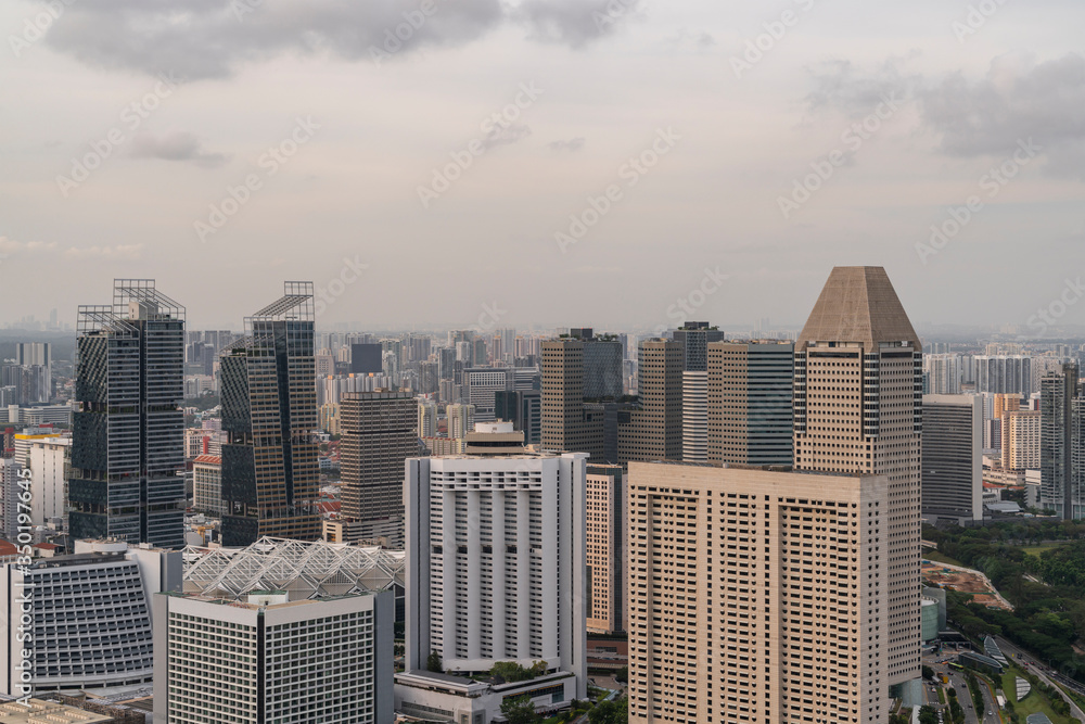Picturesque panoramic view of Singapore city at sunset. Financial and trading center hub in Asia region. Concept of success. Modern buildings in high-tech world. Picturesque panoramic view of Singapore city at sunset. Financial and trading center hub in Asia region. Concept of success. Modern buildings in high-tech world.