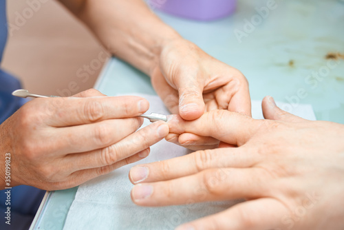 man make hygienic manicure in a beauty salon. A hand holding a piece of paper. High quality photo