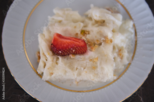 Traditional Turkish Ramadan Dessert Gullac . It is made with gullac (rice wafer or rice paper sheets) , milk, rose water, walnut, vanilla.