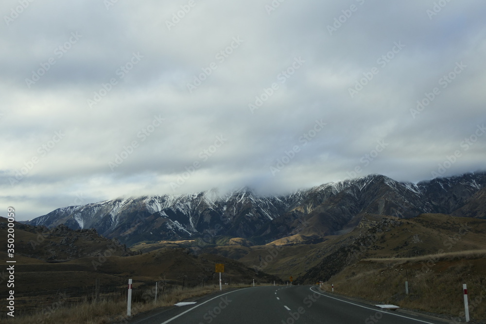 Endless wide, empty streets and beautiful scenery travelling on a road on the south island of New Zealand