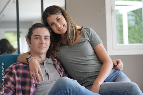 young couple smiling facing camera