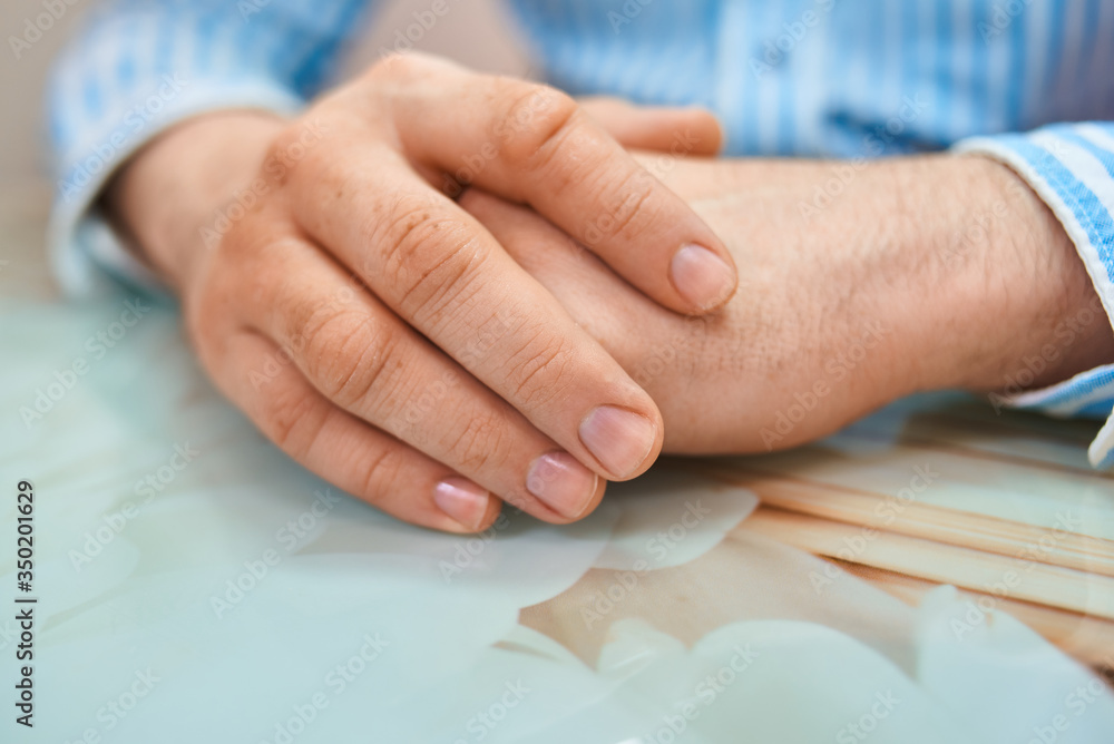 man make hygienic manicure in a beauty salon. A hand holding a piece of paper. High quality photo man make hygienic manicure in a beauty salon. A hand holding a piece of paper. High quality photo