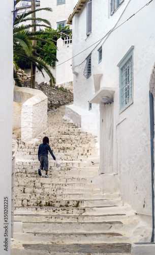 Hydra, Attica / Greece - June 6, 2010: One kid climbing the stairs in the historic village center © Manel Vinuesa