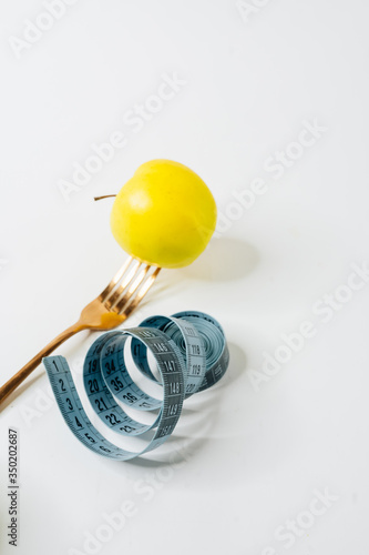 Healthy diet. Weight control. Apple on fork against white background. Healthy food concept. 