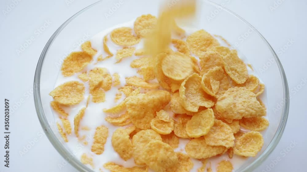 breakfast corn flakes. milk into bowl of corn flakes. Healthy breakfast. breakfast corn flakes. milk into bowl of corn flakes. Healthy breakfast.