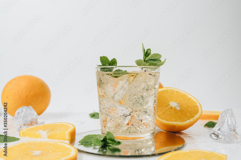 Fototapeta premium Sliced orange fruit segments isolated on white, lemonade