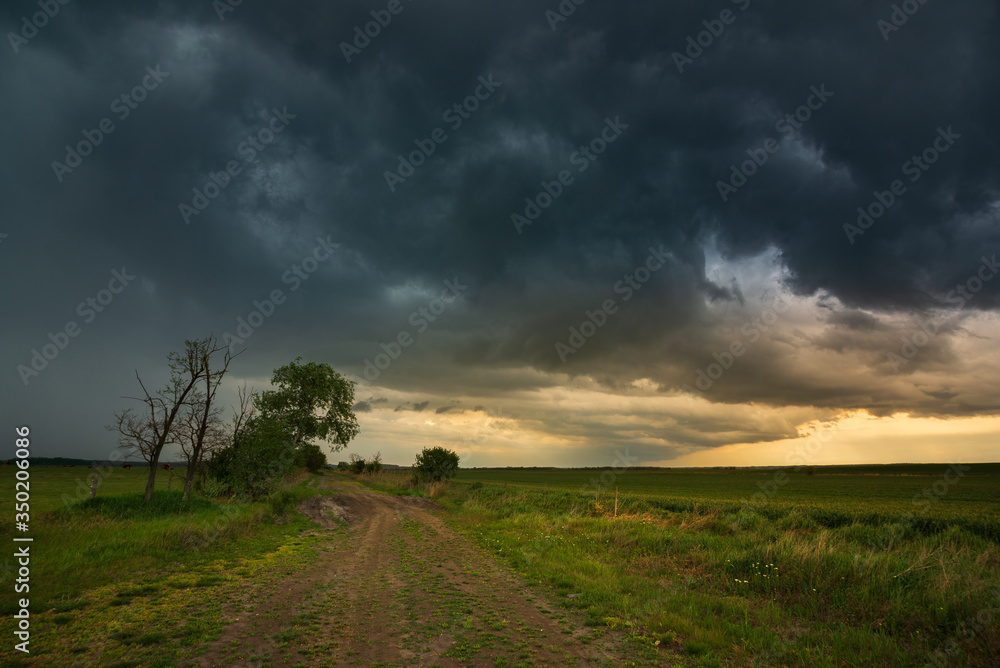 Obraz premium Storm clouds , dramatic dark sky over the rural field landscape