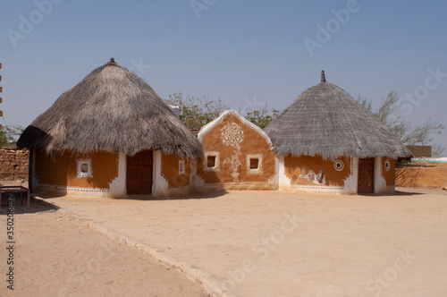 Khuri village with traditional-style hut with clay-and-dung walls and thatched roofs,  Jaisalmer, Rajasthan, India photo