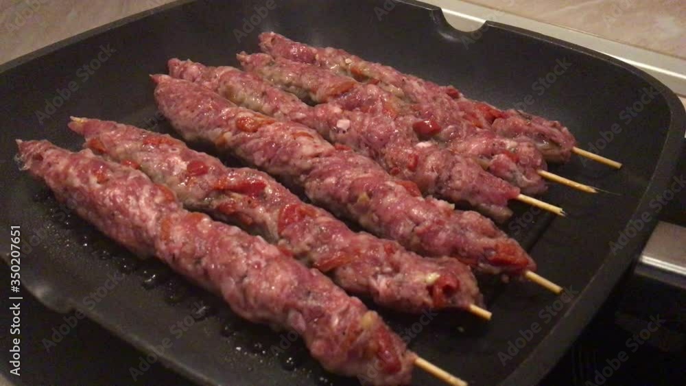Homemade Turkish Adana kebab on barbecue. Fast food on BBQ. Homemade Turkish Adana kebab on barbecue. Fast food on BBQ.