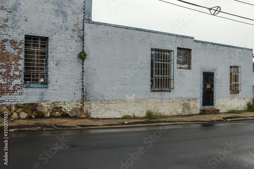 Side of old vintage warehouse building painted light blue in urban Atlanta on dreary day