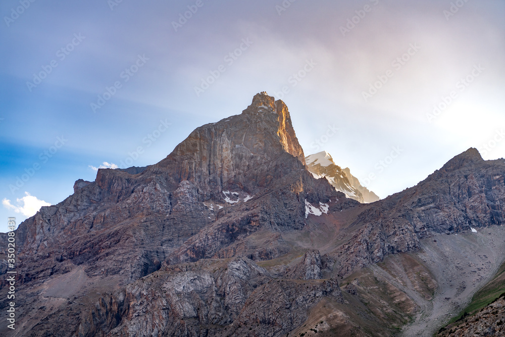 The beautiful view of blue sky and snow mountain summit near to Alaudin lake in Fann mountains in Tajikistan