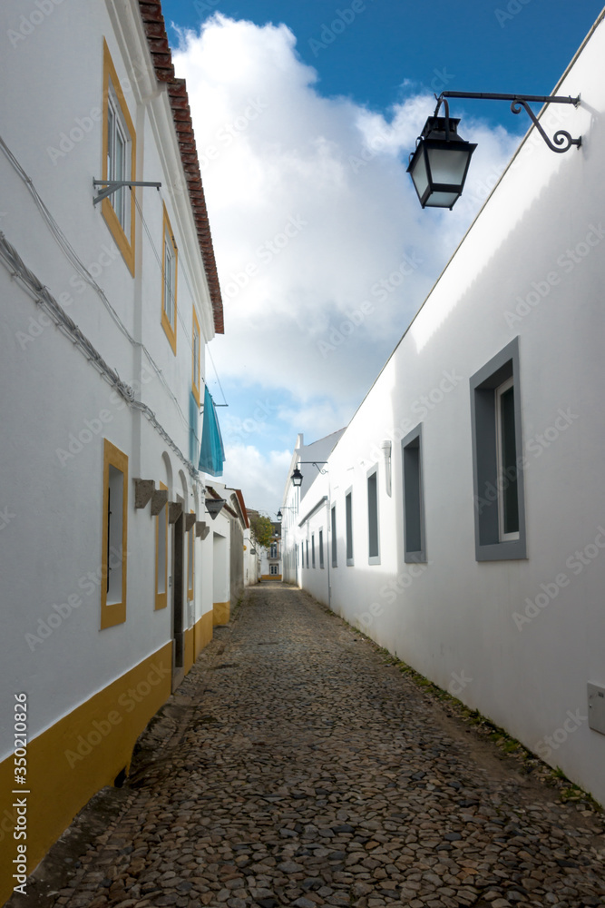 Traditional cobblestone alley in historic town Evora in Portugal