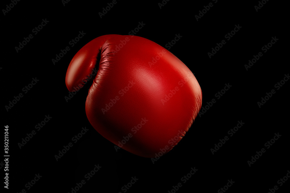 Boxers red glove. Professional sport equipment isolated on black studio background. Concept of sport, leadership, competition, healthy lifestyle in motion and action, training. Close up, copyspace.