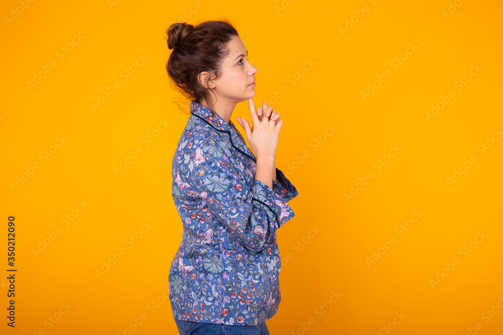 Cute and cheerful woman studio lifestyle yellow background emotions. Copy space. Cute and cheerful woman studio lifestyle yellow background emotions. Copy space.