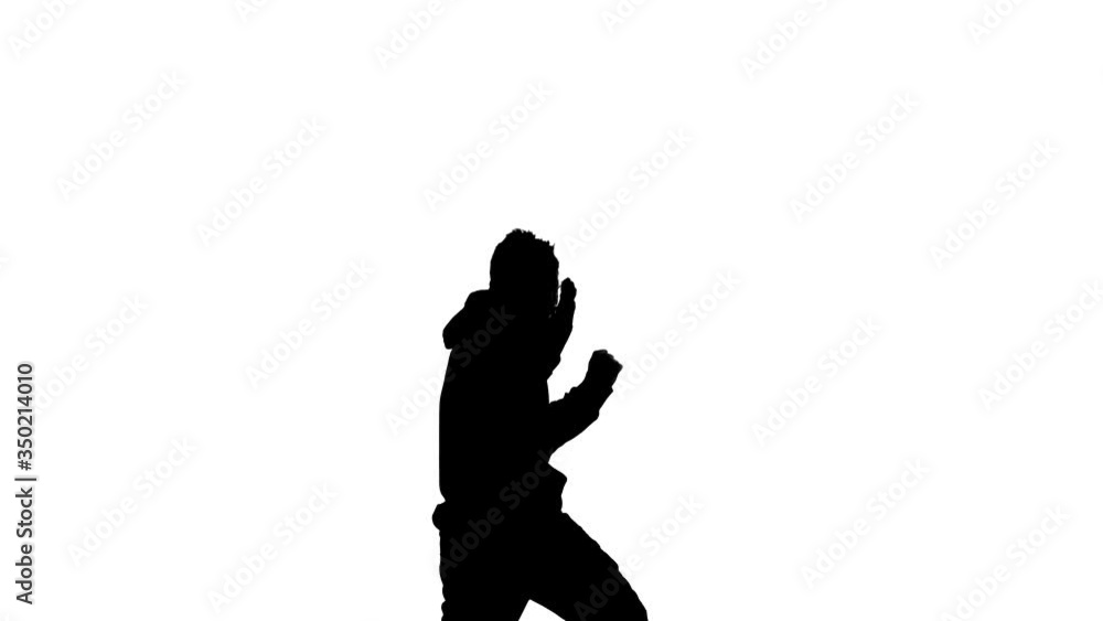 black silhouette on a white background, young energetic guy dancing hip hop, freestyle, street dance. Medium long shot black silhouette on a white background, young energetic guy dancing hip hop, freestyle, street dance. Medium long shot