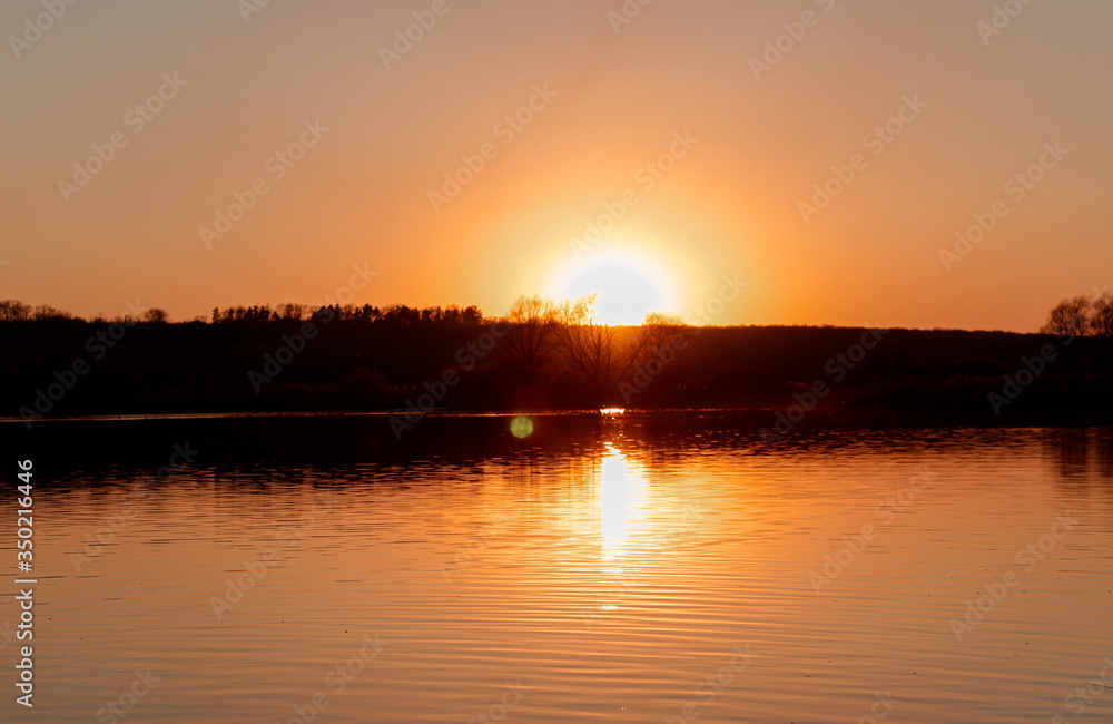 Obraz premium sunset over the river