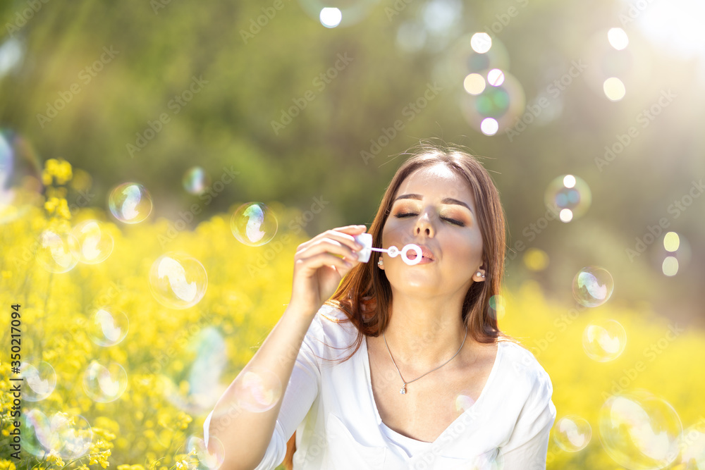 Young woman having fun with soap bubbles