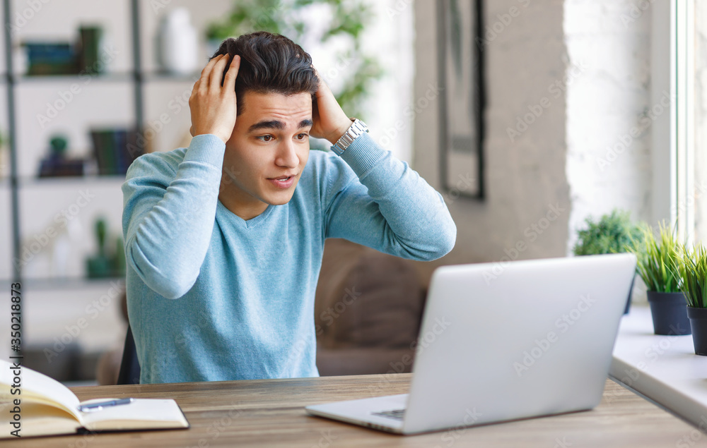 Shocked freelancer reading news on laptop. Shocked freelancer reading news on laptop.