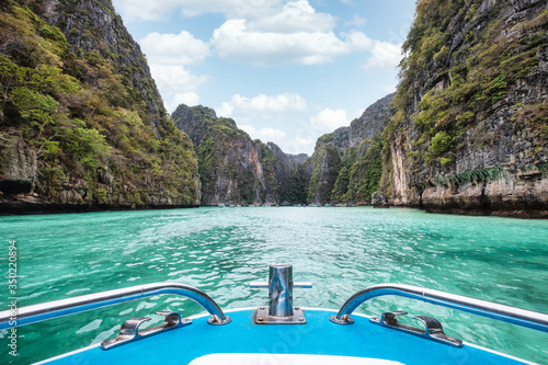 Front of boat sailing on Pileh lagoon with cliff limestone of turquoise sea in Phi Phi island