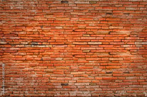 Brick wall of orange brown color, old heritage style. Aged and ruined wall background.