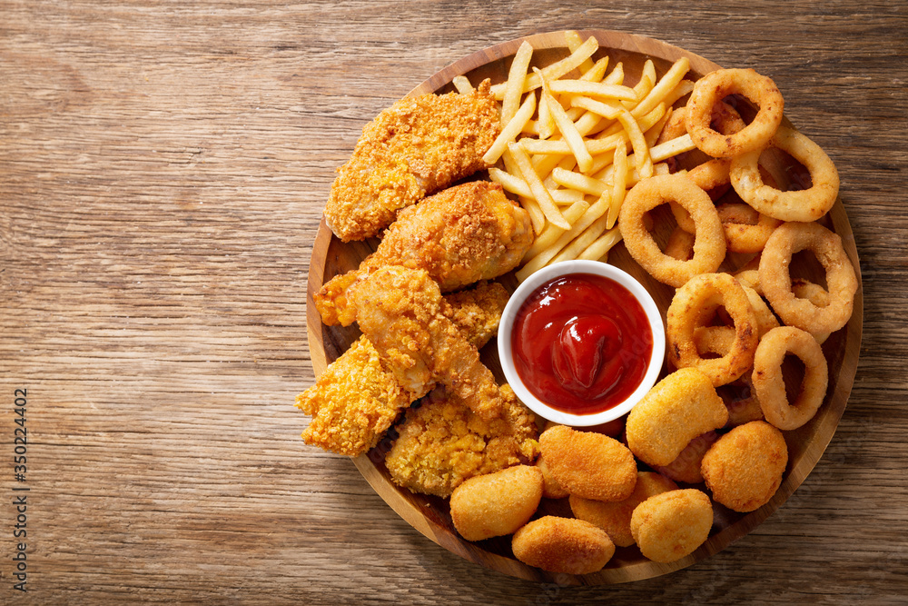 fast food meals onion rings, french fries, chicken nuggets and fried
