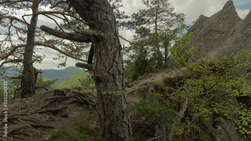 Caucasian Hiker Walks on Tough Terrain on Top of Mountain Range Caucasian Hiker Walks on Tough Terrain on Top of Mountain Range