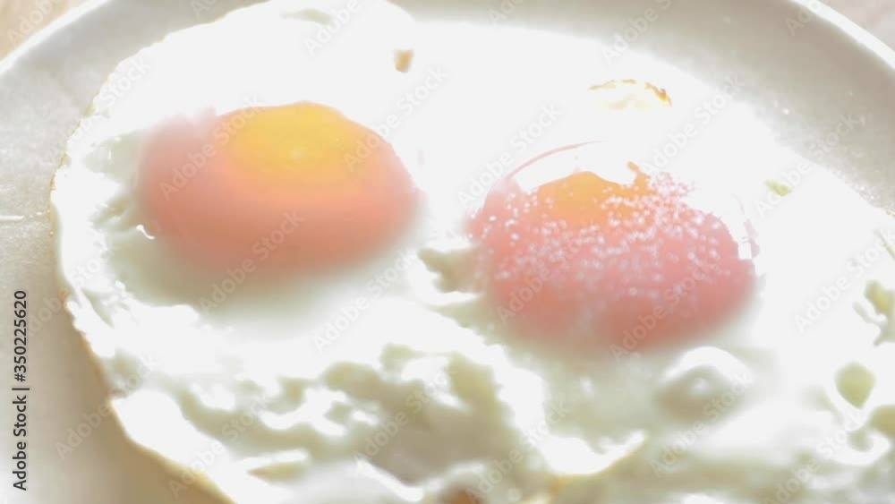 Fried eggs seasoning with salt and pepper Fried eggs seasoning with salt and pepper