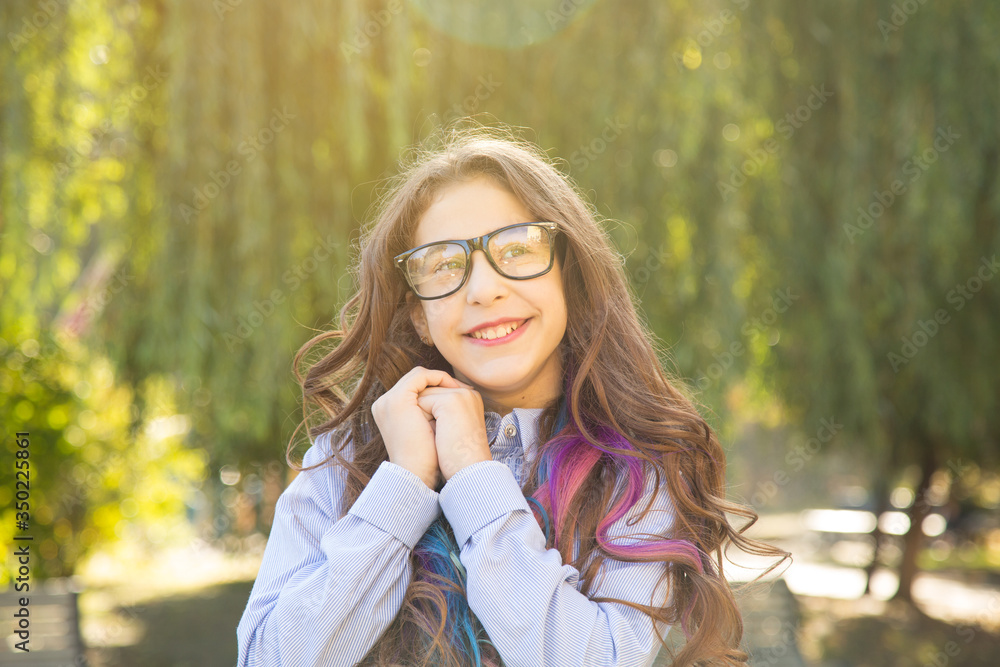 Portrait of happy beautiful girl in glasses. Dream and make wishes.