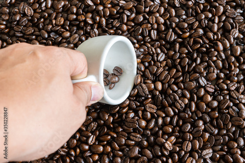 coffee beans with hand and shot cup