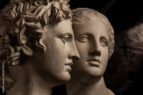Photo Group gypsum busts of ancient statues human heads for artists on a dark background