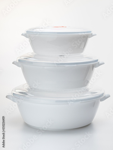 set of white containers for storing food in the kitchen