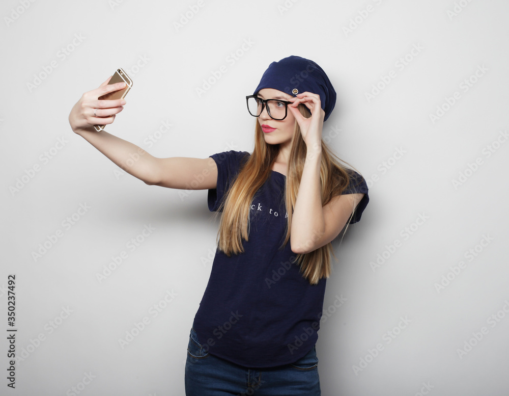 Pretty young woman taking selfie. Pretty young woman taking selfie.