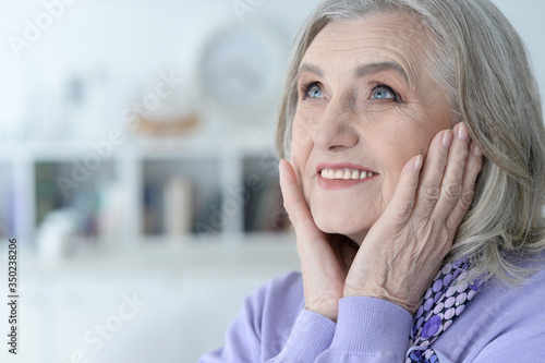 Portrait of happy beautiful senior woman posing at home